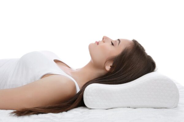 young woman sleeping on bed with orthopedic pillow