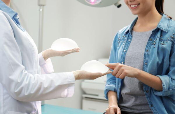 Woman deciding on breast implants in medical office